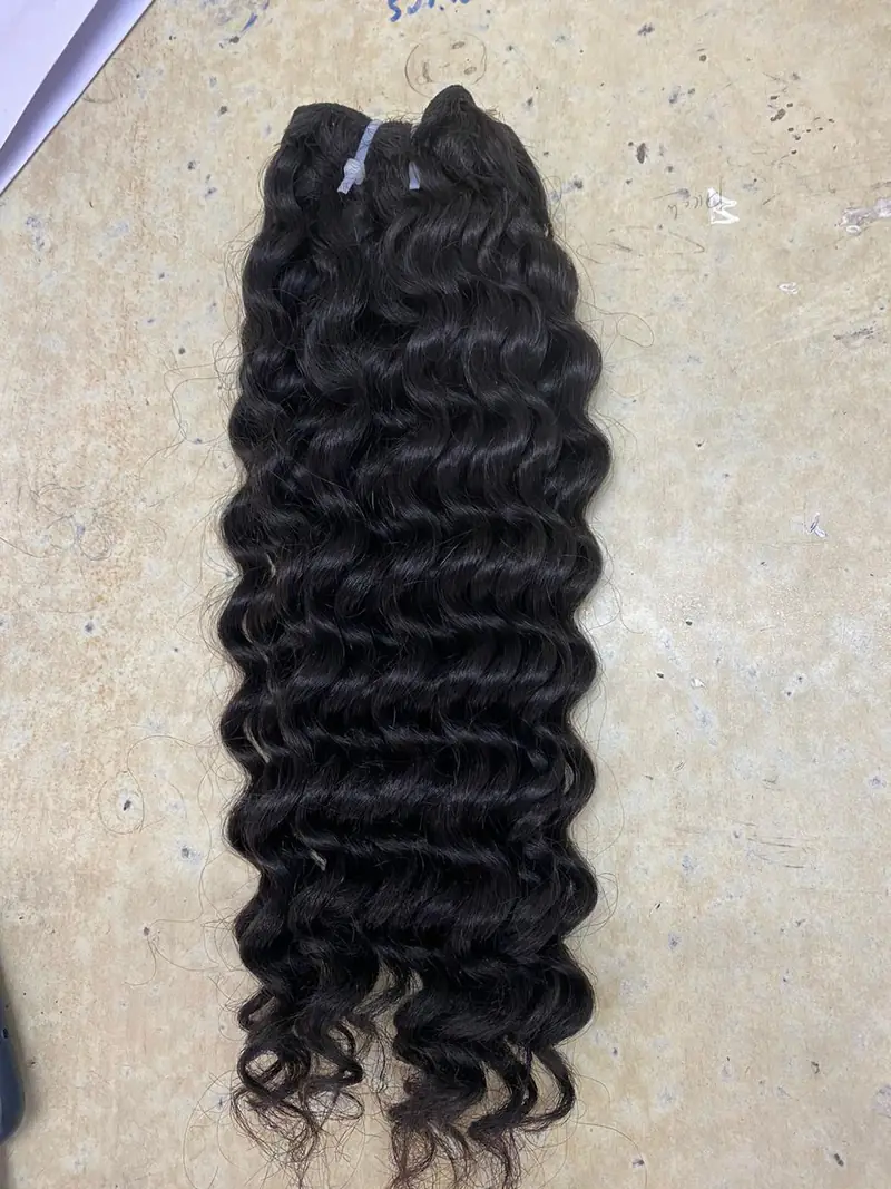 A black curly hair weft laid flat